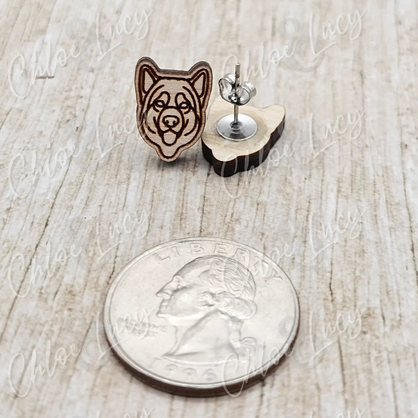 Wooden dog face stud earrings with stainless steel posts next to a US quarter on wood surface