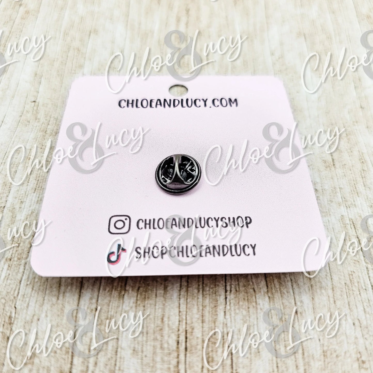 Small silver peace sign pin on pink card backing, fun accessory gift for friends