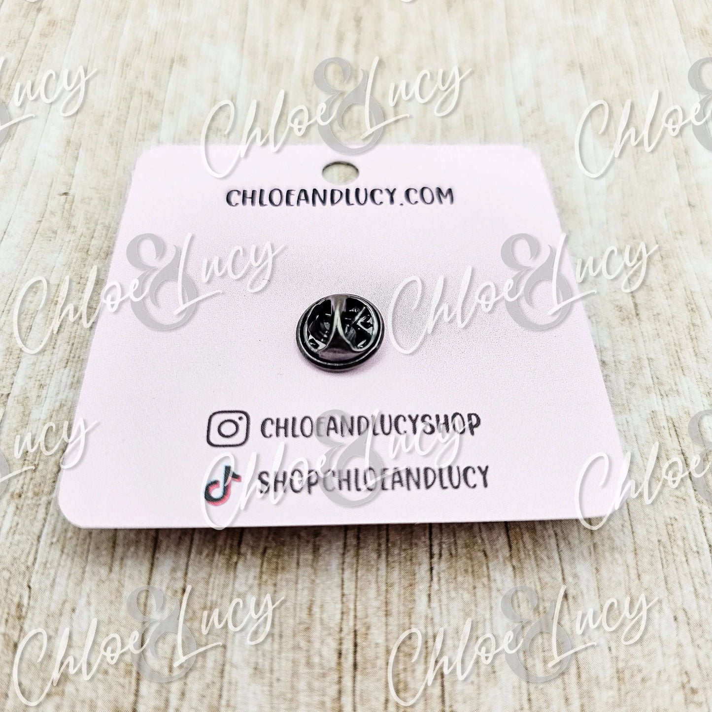 Small silver peace sign pin on pink card backing, fun accessory gift for friends