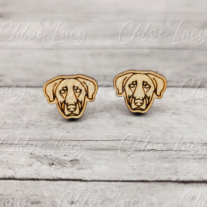 Wooden dog face stud earrings on a rustic wooden background