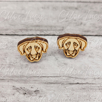 Wooden dog face stud earrings on a light textured background