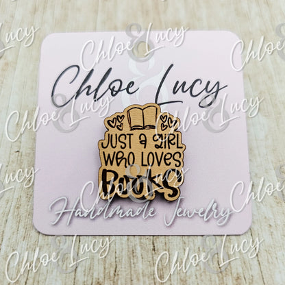 Wooden pin with open book and 'Just a girl who loves books' text on a card backing