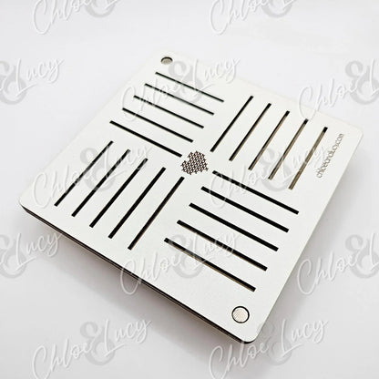 Square white laser cut wood trivet with slotted design and honeycomb detail, on white background.