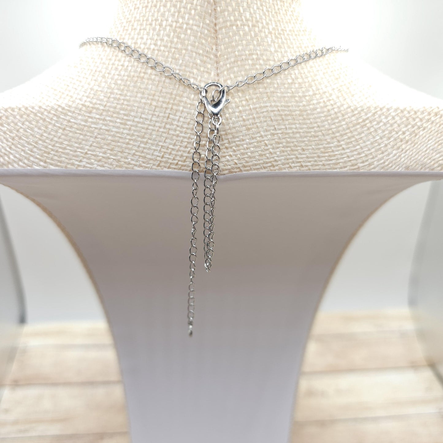 To shorten the whole necklace, loop the clasp side chain inside the clasp, and place the clasp on the other side where you'd like it to fall.
