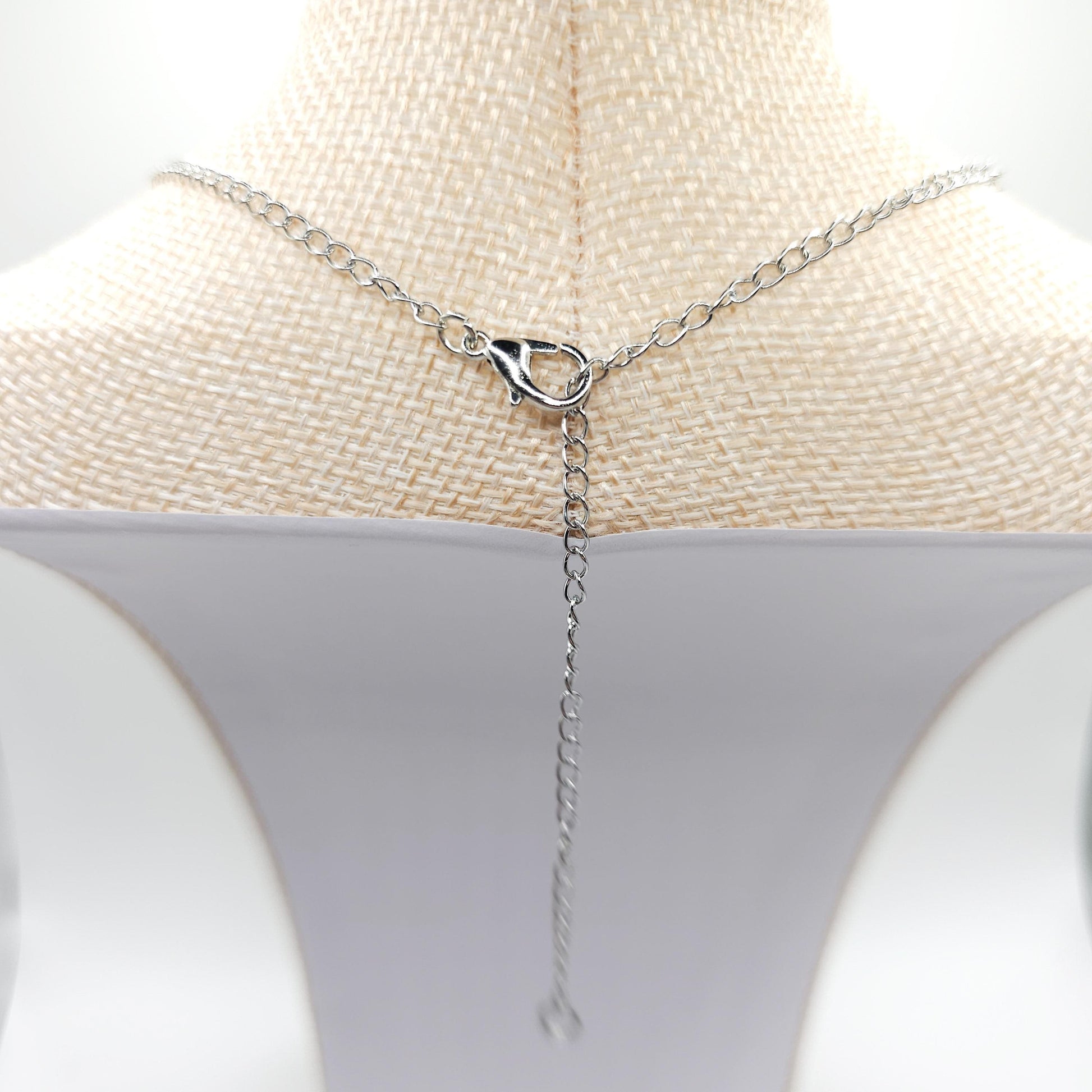 To make one side shorter, place the clasp on the chain where you'd like it to fall.